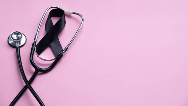 istock Black ribbon and stethoscope on pink background. Melanoma concept 2191694149