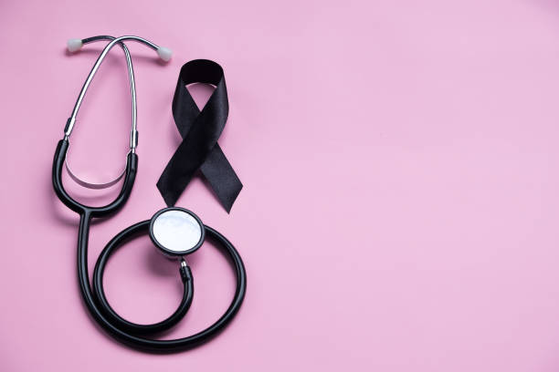 istock Black ribbon and stethoscope on pink background. Melanoma concept 2191694739