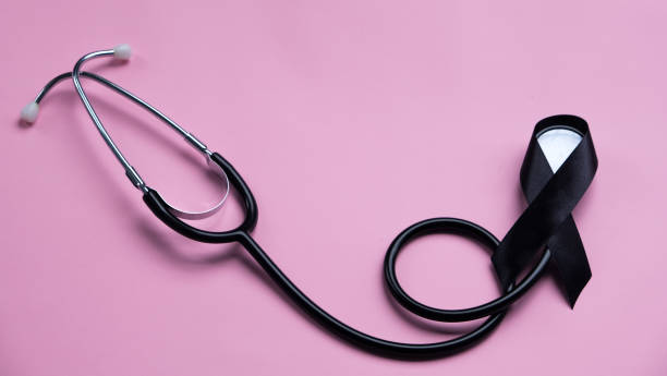 istock Black ribbon and stethoscope on pink background. Melanoma concept 2191694787
