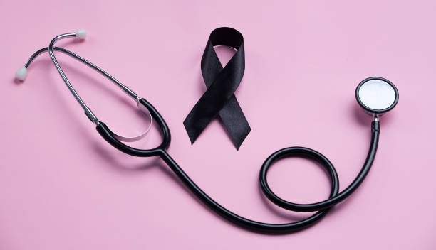 istock Black ribbon and stethoscope on pink background. Melanoma concept 2191694932