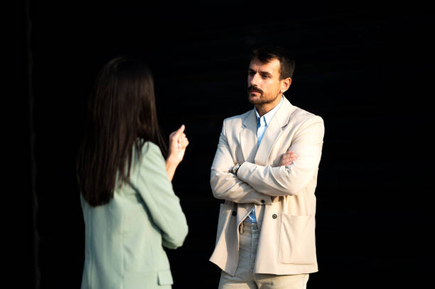 Young man reacts subtly to the unpleasant sweat odor from the woman's armpit, her expression oblivious