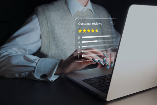 istock Customer Feedback in Action: A close-up image of a person working on a laptop, with a transparent overlay displaying a customer review rating system. 2191700680