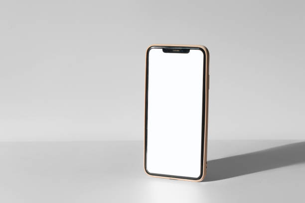 istock A phone is sitting on a table with a white background 2191705564