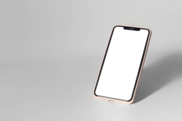 istock A phone is sitting on a table with a white background 2191705572