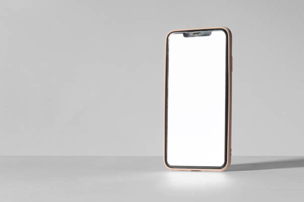 istock A phone is sitting on a table with a white background 2191705575