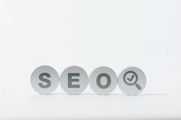 Metal plates spelling out SEO with search icons, representing digital marketing