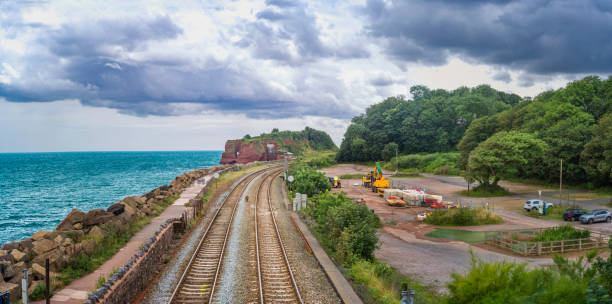 The railway passes between Elephant Rock on the seashore and the construction site.