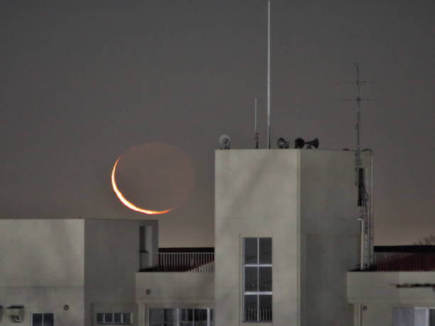 Tokyo,Japan - December 29,  2024: Rising Crescent moon with earthshine at winter dawn