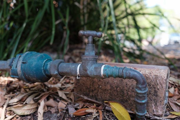 Close-up on an old metal faucet in a garden.