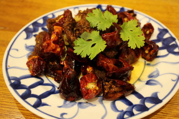 istock Sichuan cuisine (Chinese cuisine): fried beef and chili peppers with coriander 2191715809