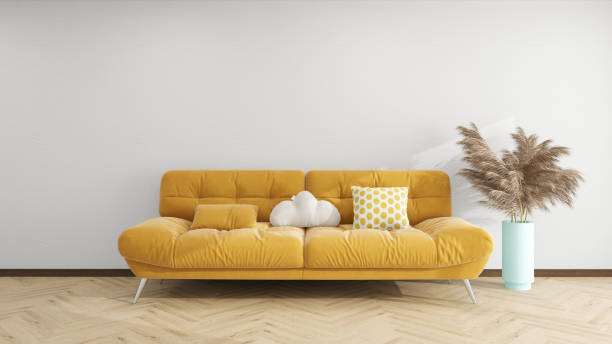istock Modern living room with a vibrant yellow tufted sofa, decorative pillows, a cloud-shaped cushion, and a tall vase with pampas grass on a wooden herringbone floor. 2191717684
