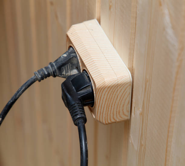 istock A wooden plug box with two outlets and a black cord plugged into it 2191718114