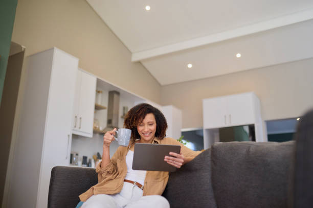 istock Cozy Connection: Woman Relaxing with Tablet 2191718214