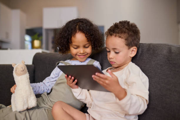 istock Sibling Screen Time with a Plush Friend 2191718259