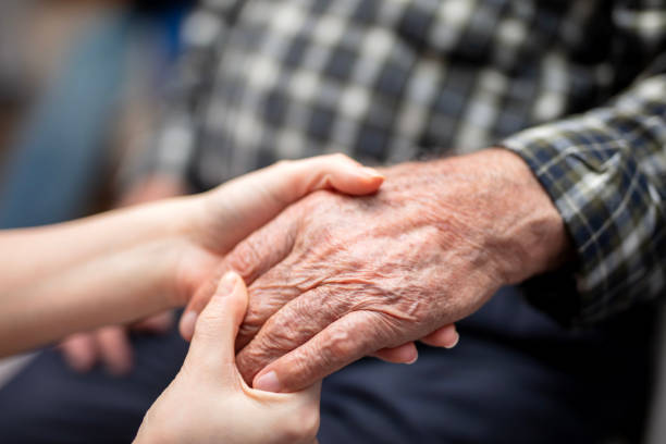 istock Close-Up of Elderly Hands with Supportive Younger 2191720136