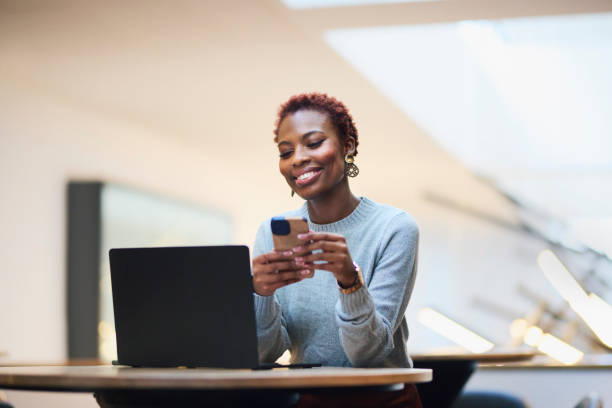 istock Smiling Woman Enjoying Phone Break with Laptop 2191720444
