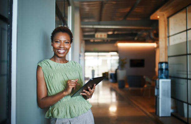 Confident Businesswoman with Tablet in Modern Office
