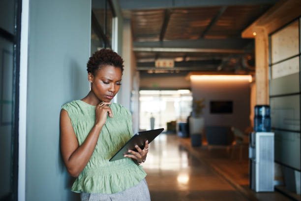 istock Contemplative Woman with Tablet in Modern Office 2191721103