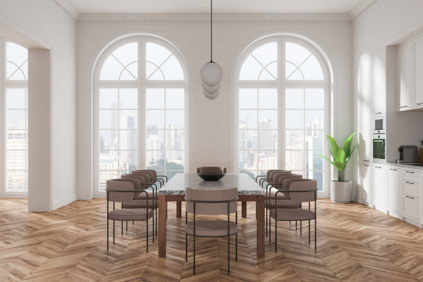 istock Modern kitchen dining area with large windows, wood flooring, and elegant contemporary furniture in a spacious home interior setting. 3D Rendering 2191723586