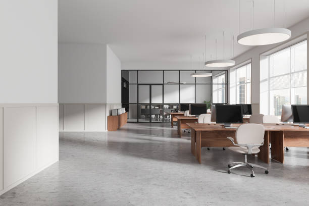 istock Modern open-space office interior with wooden desks, chairs, and computers. Minimalist design, large windows, and glass partitions. Bright and spacious. 3D Rendering 2191723711