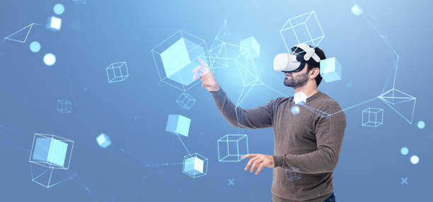 istock Young man in vr glasses finger touch data blocks in cyberspace 2191724845