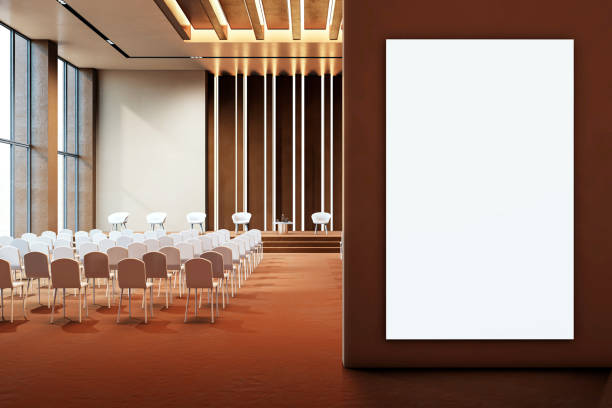 istock Modern conference hall interior with empty seats, stage, and large vertical banner on a wall. 3D Rendering 2191725675