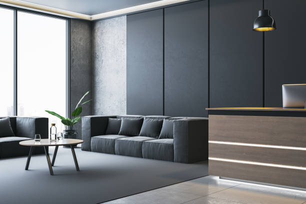 istock Modern waiting area in office interior with black sofas, wooden reception desk, and large window offering city view. 3D Rendering 2191725972