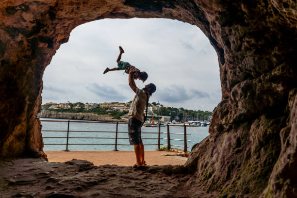 istock Father lifting son in coves del drac, mallorca, spain 2191726239