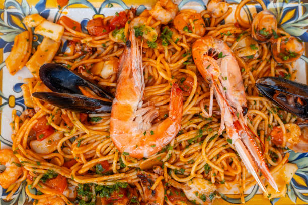 A plate of spaghetti with shrimp and mussels