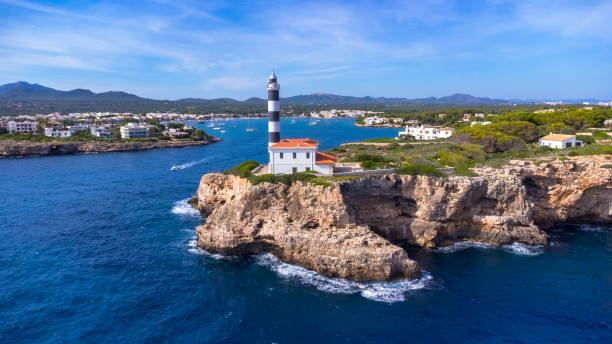 istock Portocolom lighthouse shining over mallorca coast on a sunny day 2191726435