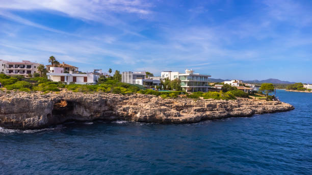 istock Portocolom lighthouse overlooking picturesque coastline in mallorca, spain 2191726436
