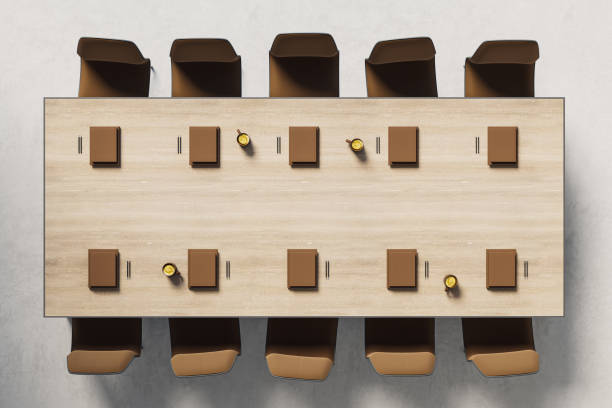 istock Top view of modern conference room table with chairs, notebooks, and coffee cups, arranged neatly on wooden surface in bright workspace. 3D Rendering 2191726560
