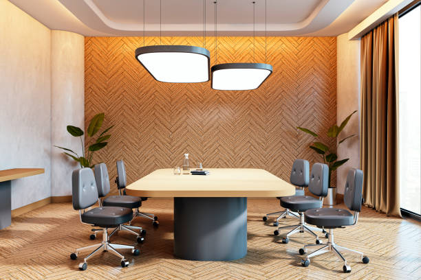istock Modern conference room interior with a stylish table, chairs, and warm lighting, featuring a wooden herringbone wall and large windows. 3D Rendering 2191726562