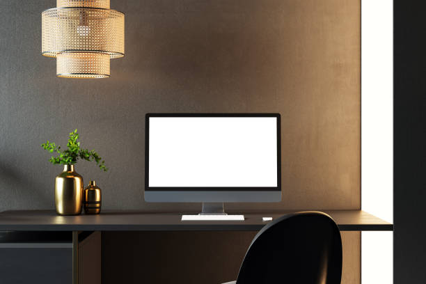istock Minimalist desk setup with desktop computer, keyboard, and mouse on a black desk, illuminated by a pendant lamp in a modern office room. 3D Rendering 2191726680