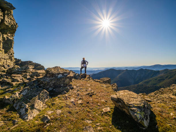 istock Woman observing the landscape in the mountains between cliffs in extreme terrain 2191728471