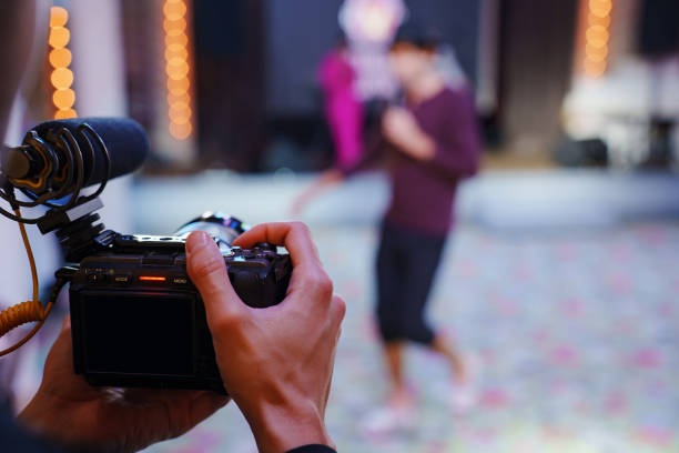 istock Men's hands with a professional camera are filming a performance at a banquet. 2191731377