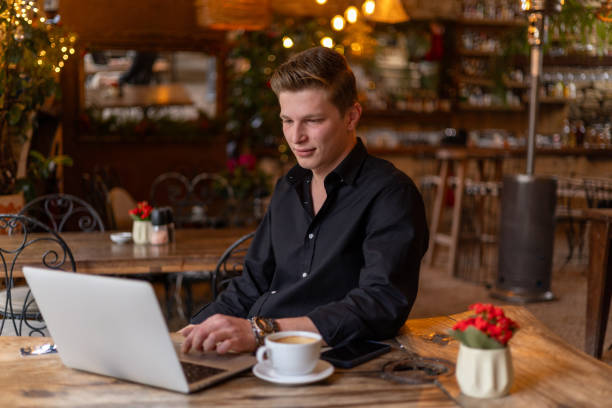 istock Young businessman working on laptop in cozy cafe 2191735189