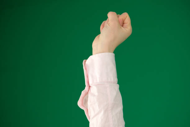 expression of emotions with hands unrecognizable people hands palms fingers close-up on a green background chromakey feelings. Female hand fist