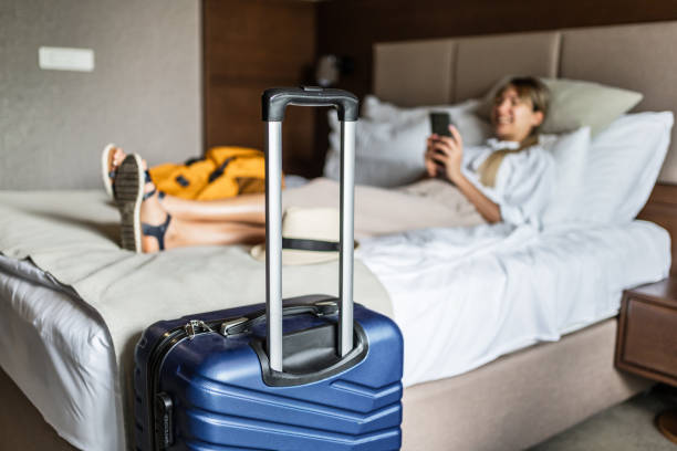 istock Woman using phone in a hotel room 2191736209