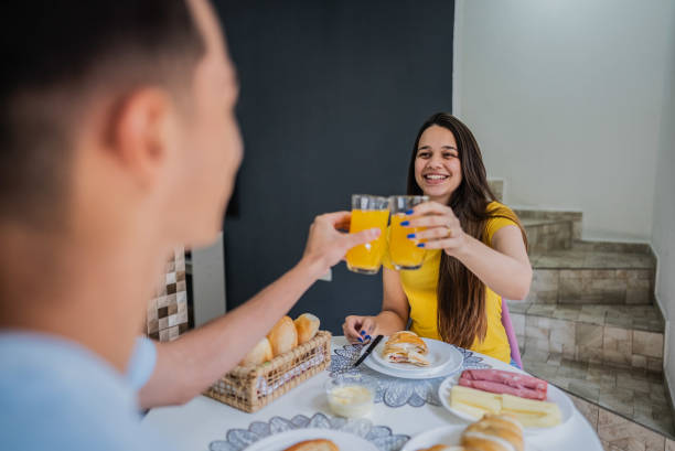 istock Young woman toasting while having breakfast with her husband in the kitchen at home 2191738080