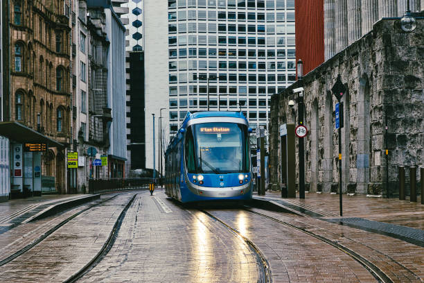 istock Blue Tram on City Tram Tracks Approaching  Station in Birmingham, UK. 2191738274