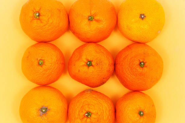 istock Tangerines on a yellow background. 2191738655