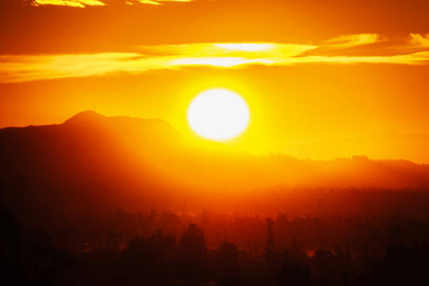 Fiery sunrise behind Mt Hollywood and Griffith Park in Los Angeles California.