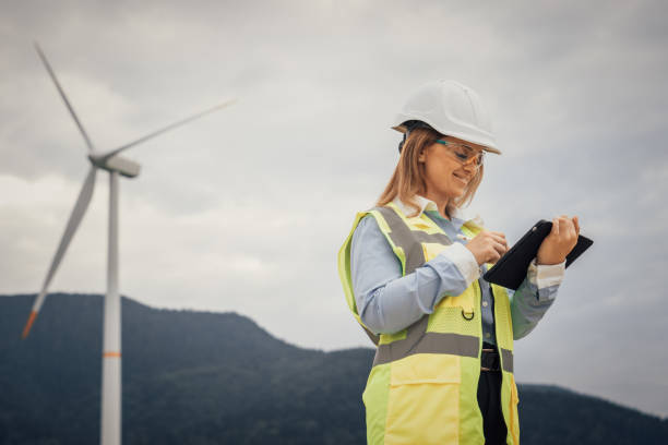 istock A skilled female engineer monitors wind turbines with a tablet, ensuring optimal performance. Her expertise is vital for advancements in renewable energy technologies and sustainable development 2191741141
