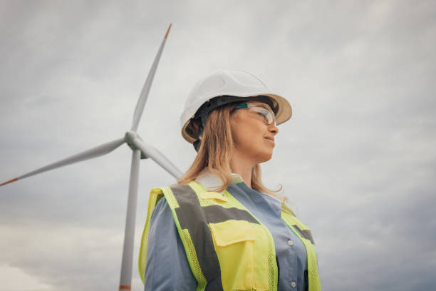 istock A Female Engineer stands confidently at a vast, sprawling wind farm, showcasing her strength and expertise in a maledominated field while symbolizing the future of sustainable energy and diversity 2191741462