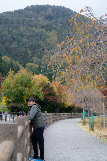 young man walking an explore  Saiko Iyashi-no Sato Nenba Fujikawaguchiko Town, Japan