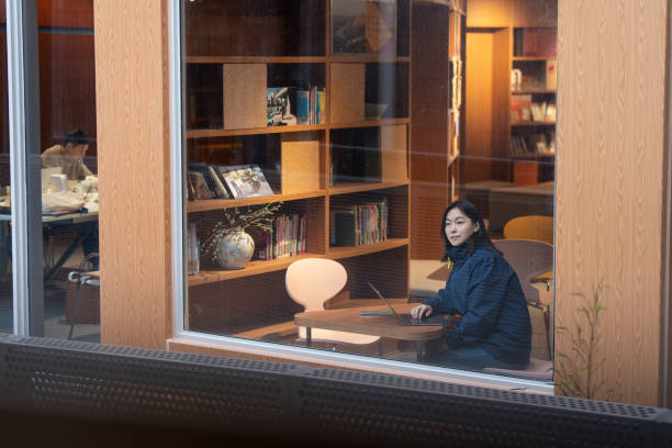 istock asian female working with laptop beside window in library 2191746567