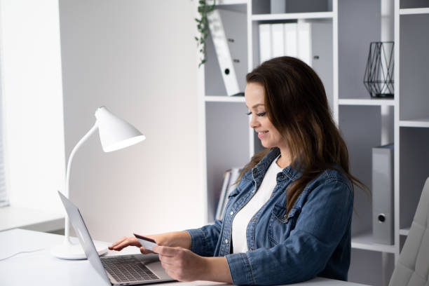 istock A woman is seen engaging in online shopping while working in a modern workspace, highlighting the blend of business and consumerism, showcasing the convenience of digital ecommerce today 2191749060