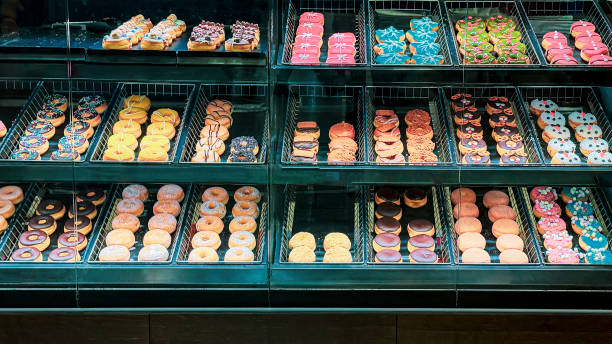 istock Display case filled with colorful donuts of various shapes and decorations 2191749827