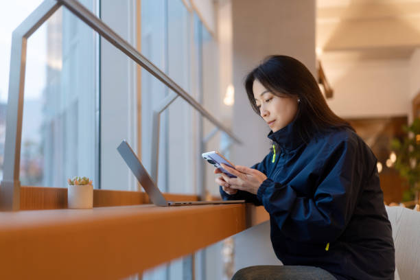 istock asian female working on laptop in office beside window 2191750834